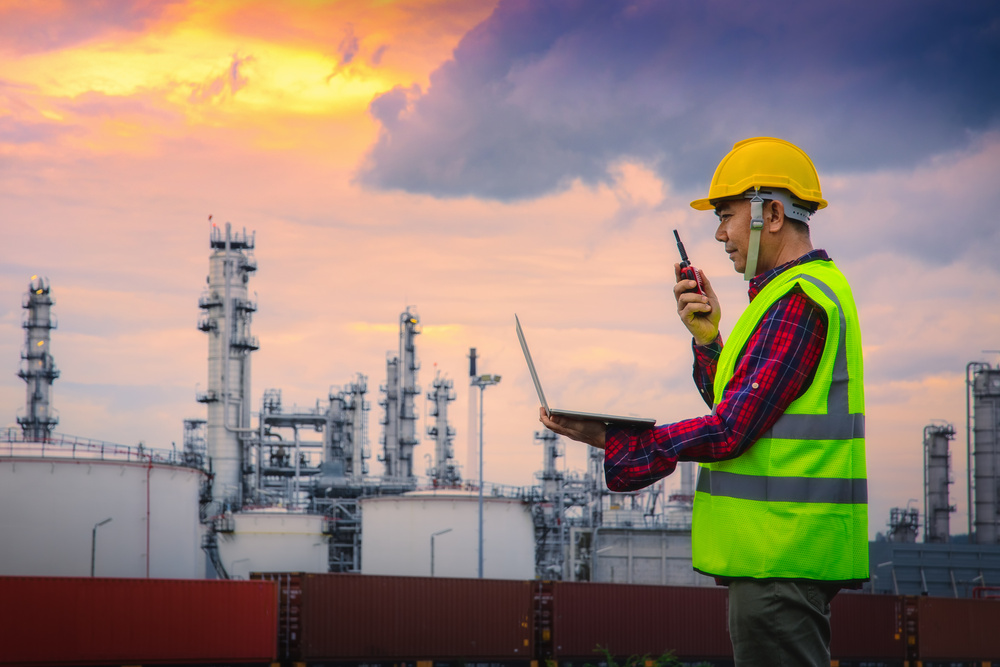 Engineer wearing safety helmet at oil refinery industry.